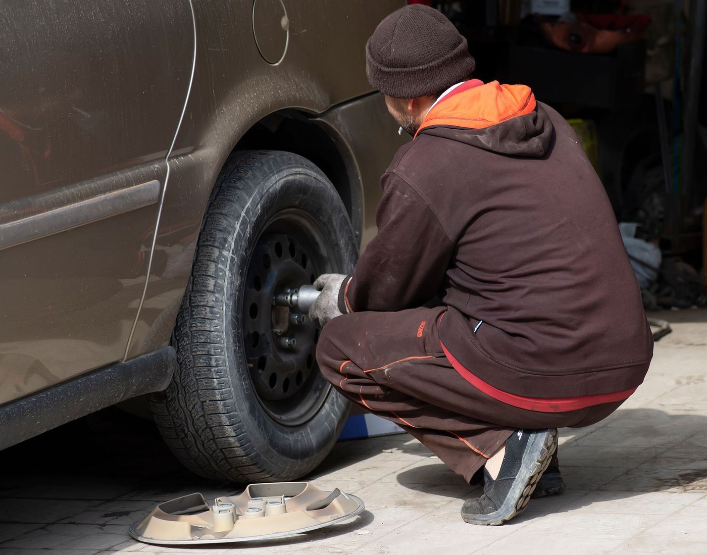 A wheel being changed at the roadside with a jack